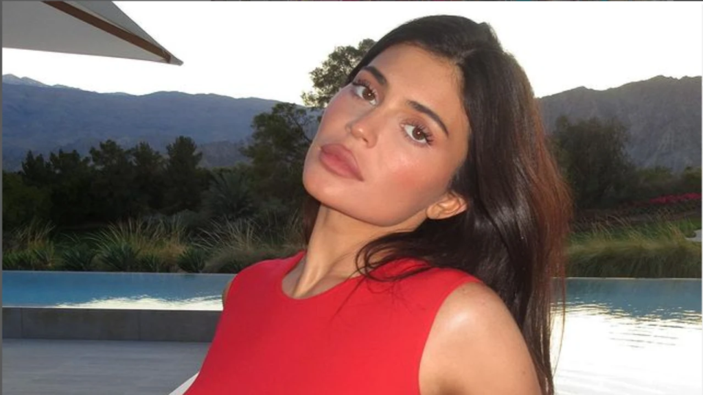 Kylie Jenner has received criticism on social media after posting a new photo of herself from the Met Gala 2023. Fans accused her of phony behavior as she held up a slice of pizza and champagne. In the picture, she wore a custom made Jean Paul Gaultier gown and posed with designer Haider Ackermann. Netizens have criticized the reality show star, with one writing, "No one with that body eats pizza". Find out more about the controversy surrounding Kylie's post here.