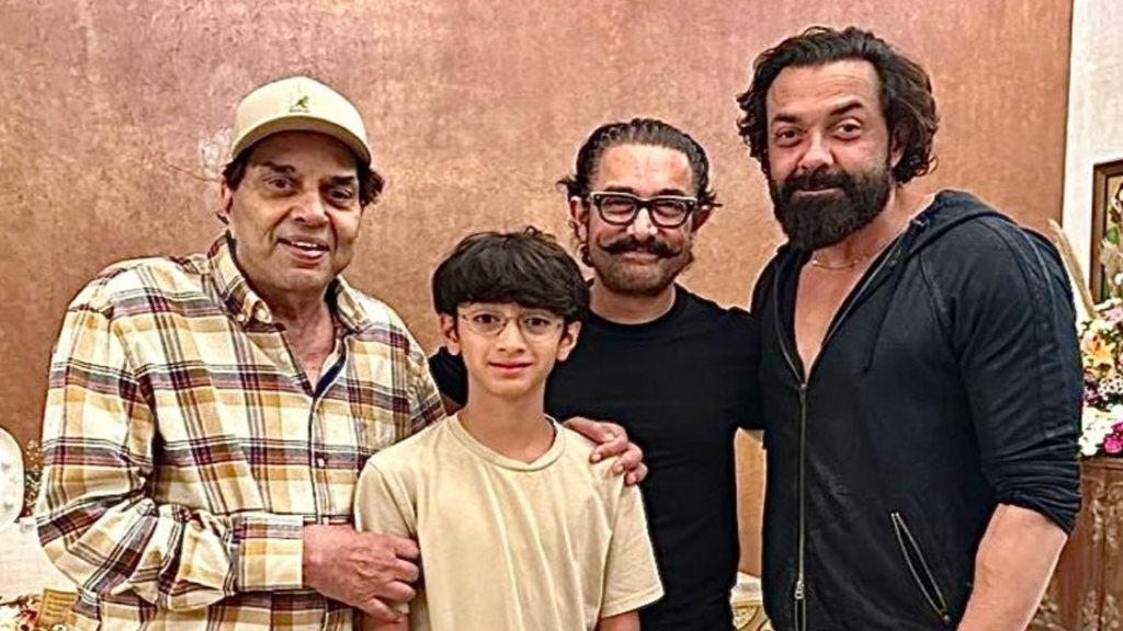 Legendary actor Dharmendra and his son, popular actor Bobby Deol, created heartwarming memories as they posed alongside superstar Aamir Khan and his younger son Azad Rao Khan. The touching pictures of their meet-up have taken the internet by storm, capturing the essence of this cherished moment. The Bollywood community and fans alike express their desire to see these icons collaborate on the silver screen, making this rendezvous even more significant.