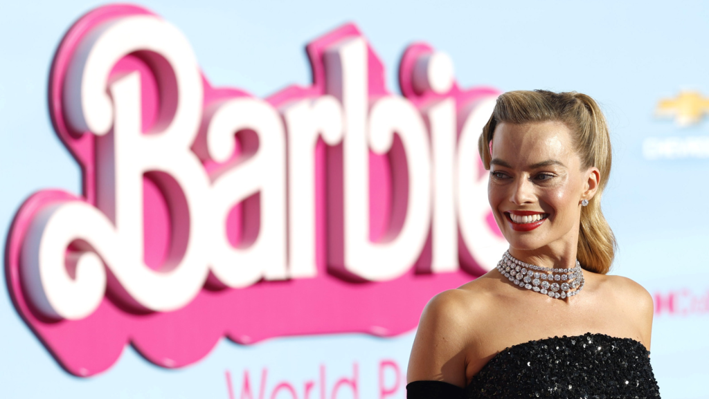 "Discover the intriguing behind-the-scenes drama as Margot Robbie shares details of a call from Oppenheimer producer Charles Roven, leading to a clash in the release dates of 'Barbie' and 'Oppenheimer.' Robbie's refusal to yield resulted in unexpected success, creating the Barbenheimer phenomenon."

