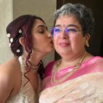 In an intimate capture, Ira Khan shares a kiss with her mother, Reena Dutta, during an unseen mehendi ceremony. Explore the warmth of their bond in this touching moment between mother and daughter.